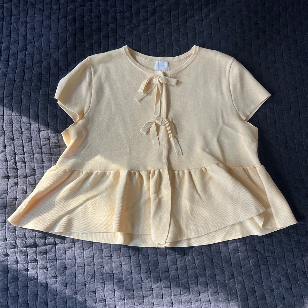 Charming Yellow Peplum Top with Bow Accents